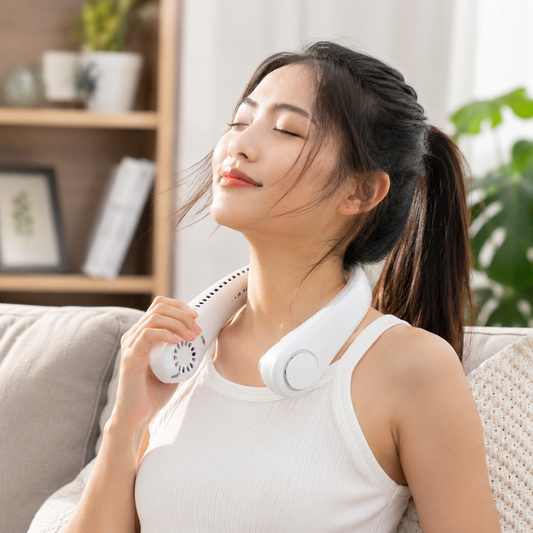 Person wearing Novu portable neck fan hands-free outdoors on a sunny day
